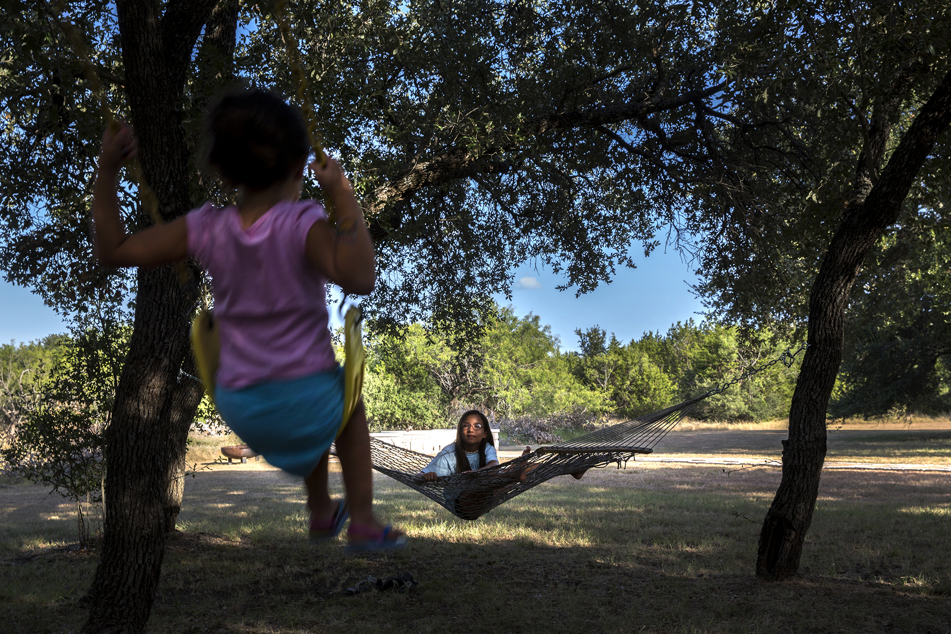 Hannah Welch, 10, watches her sister Haley, 4, on the swing outside their home in Double Horn.