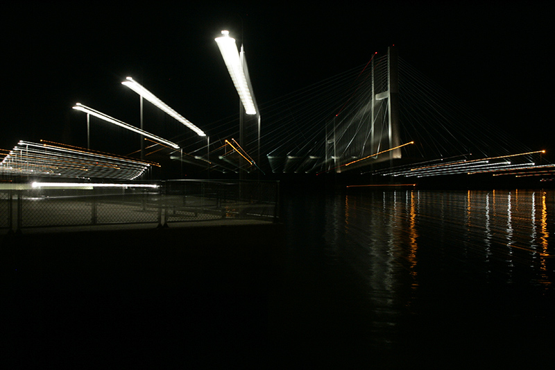 Light streaks from the room lens during a long exposure frame the Great River Bridge over the Mississippi River September 30, 2006 in Burlington. | John Gaines | The Hawk Eye