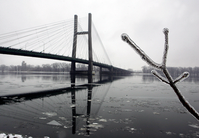A branch is coated with ice and frames the Great River Bridge following a ice storm December 11, 2007 along the Mississippi River in Burlington. | John Lovretta | The Hawk Eye