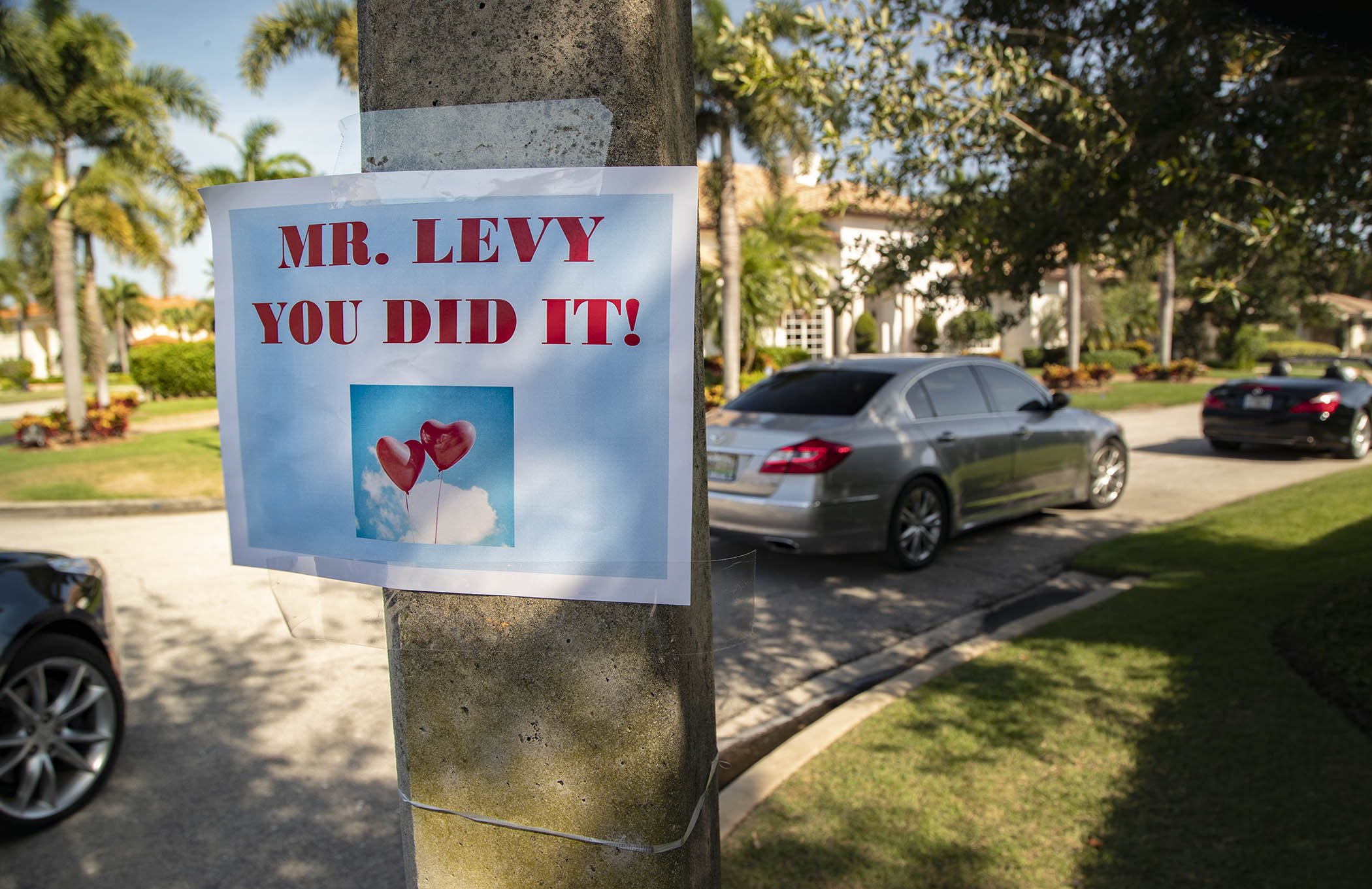 “Mr. Levy you did it,” says the sign outside the Boca Raton home of Alan Levy, who survived a hospital stay with COVID-19.