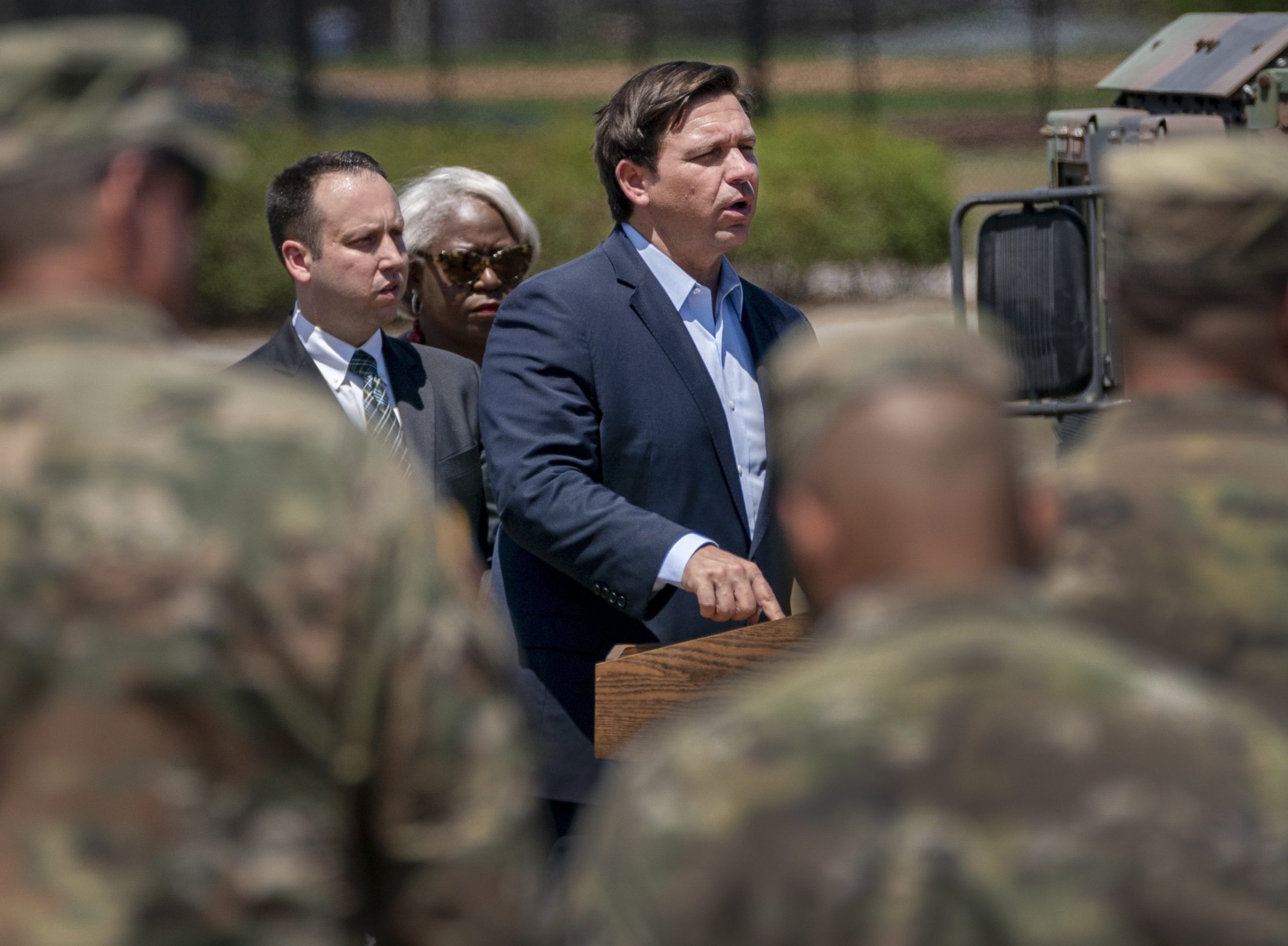 Florida Gov. Ron DeSantis speaks March 30, 2020, at a news conference with Palm Beach County Mayor Dave Kerner and County Administrator Verdenia Baker at a drive-thru COVID-19 testing facility in West Palm Beach.
